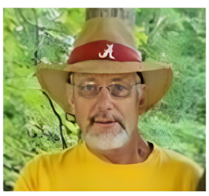 Man wearing tan hat and glasses outdoors