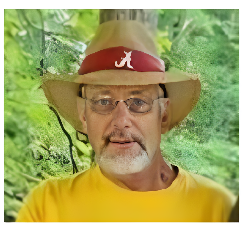 Man wearing tan hat and glasses outdoors