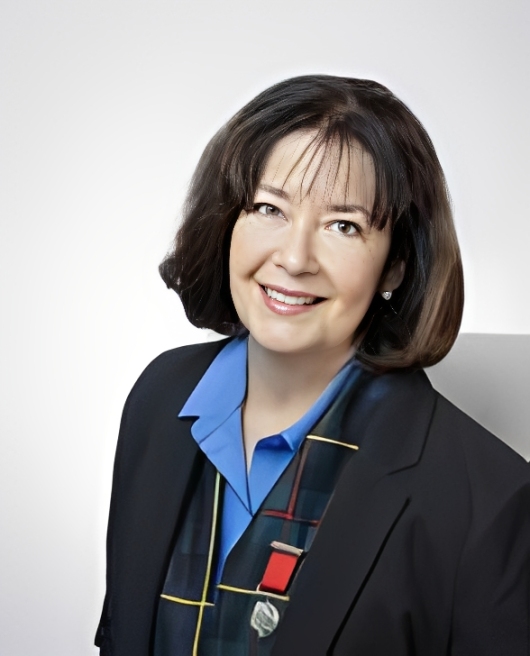 Smiling woman in a black blazer.