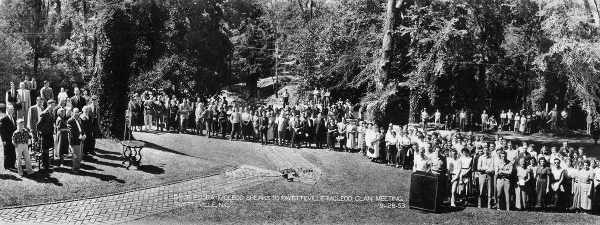 Large crowd gathered outdoors in park