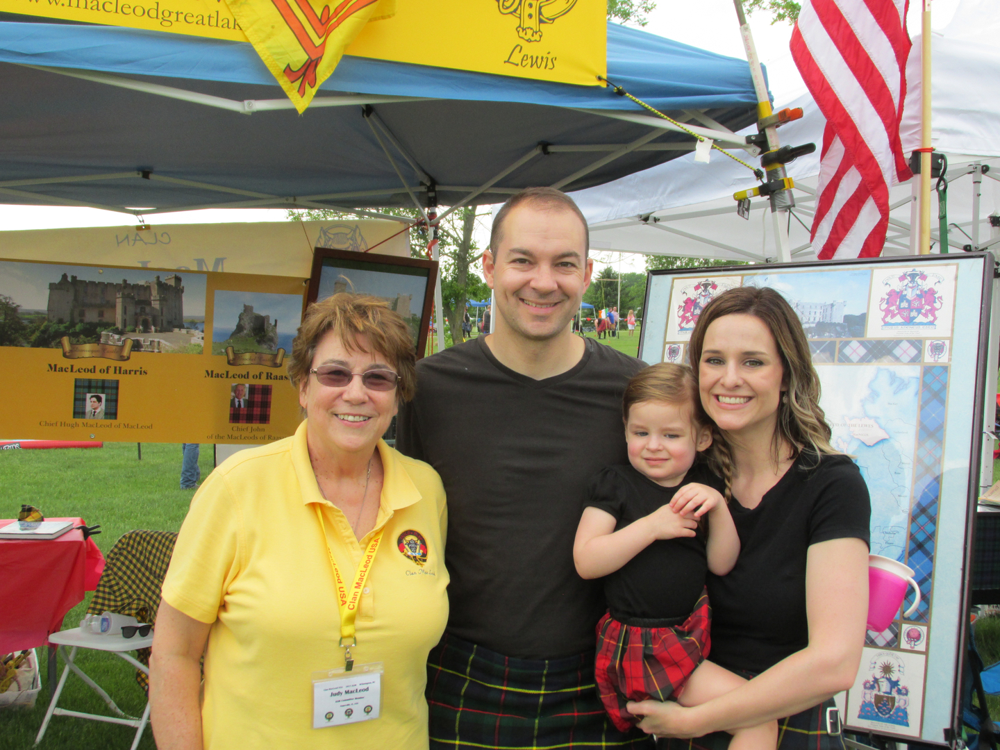 Family posing at outdoor cultural festival.
