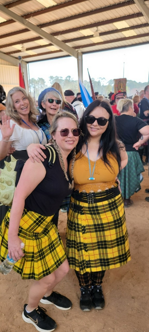 People wearing plaid skirts at an event.