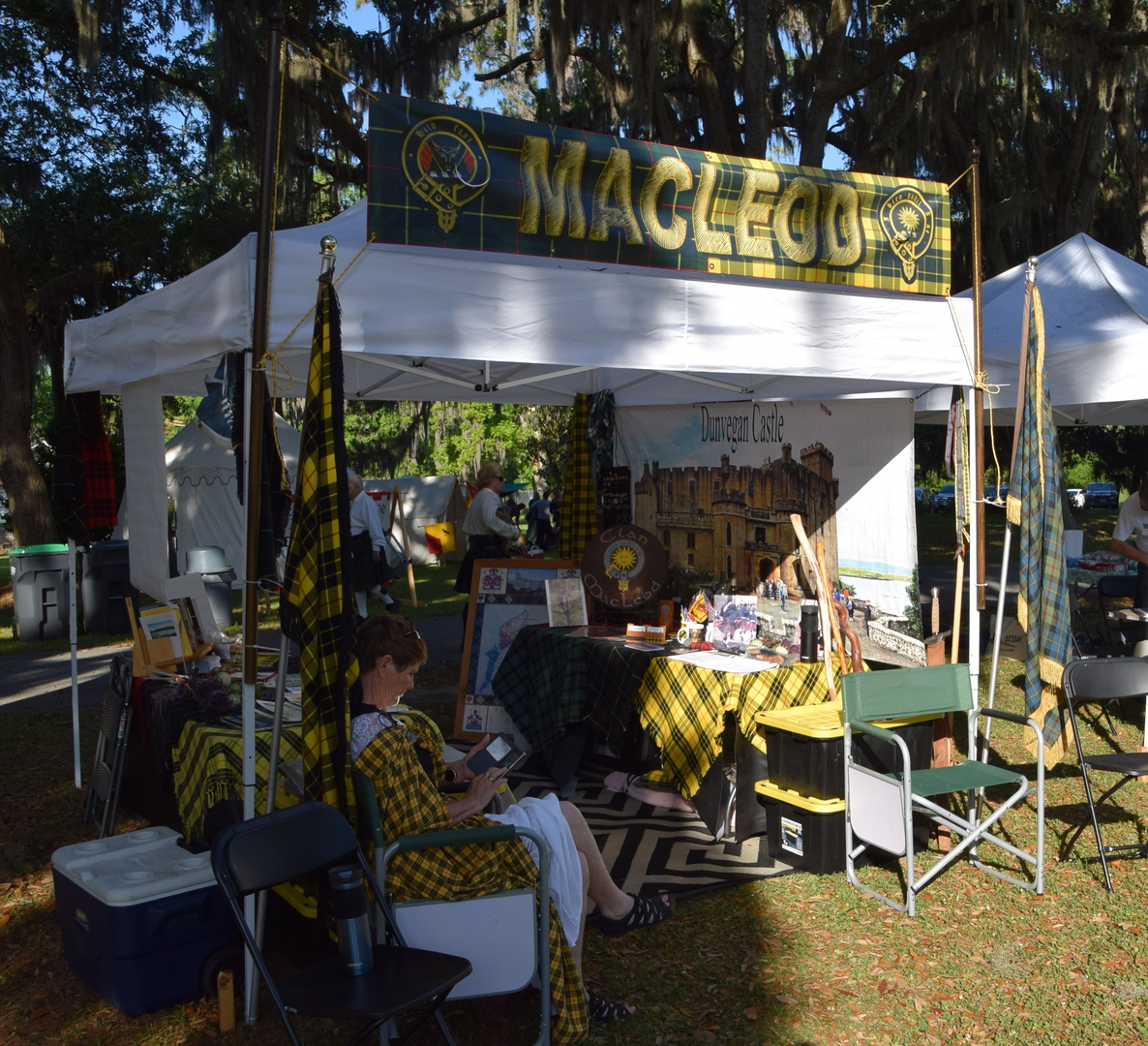 Scottish-themed booth with seated woman reading.