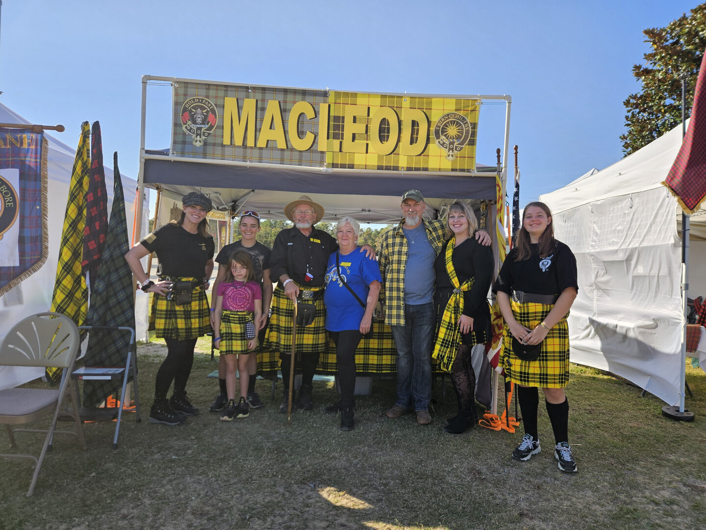 Group in kilts at MacLeod festival tent.