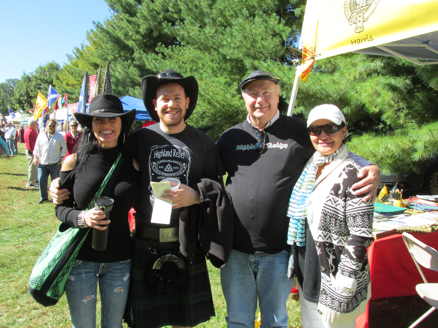 Group of people smiling at outdoor event.