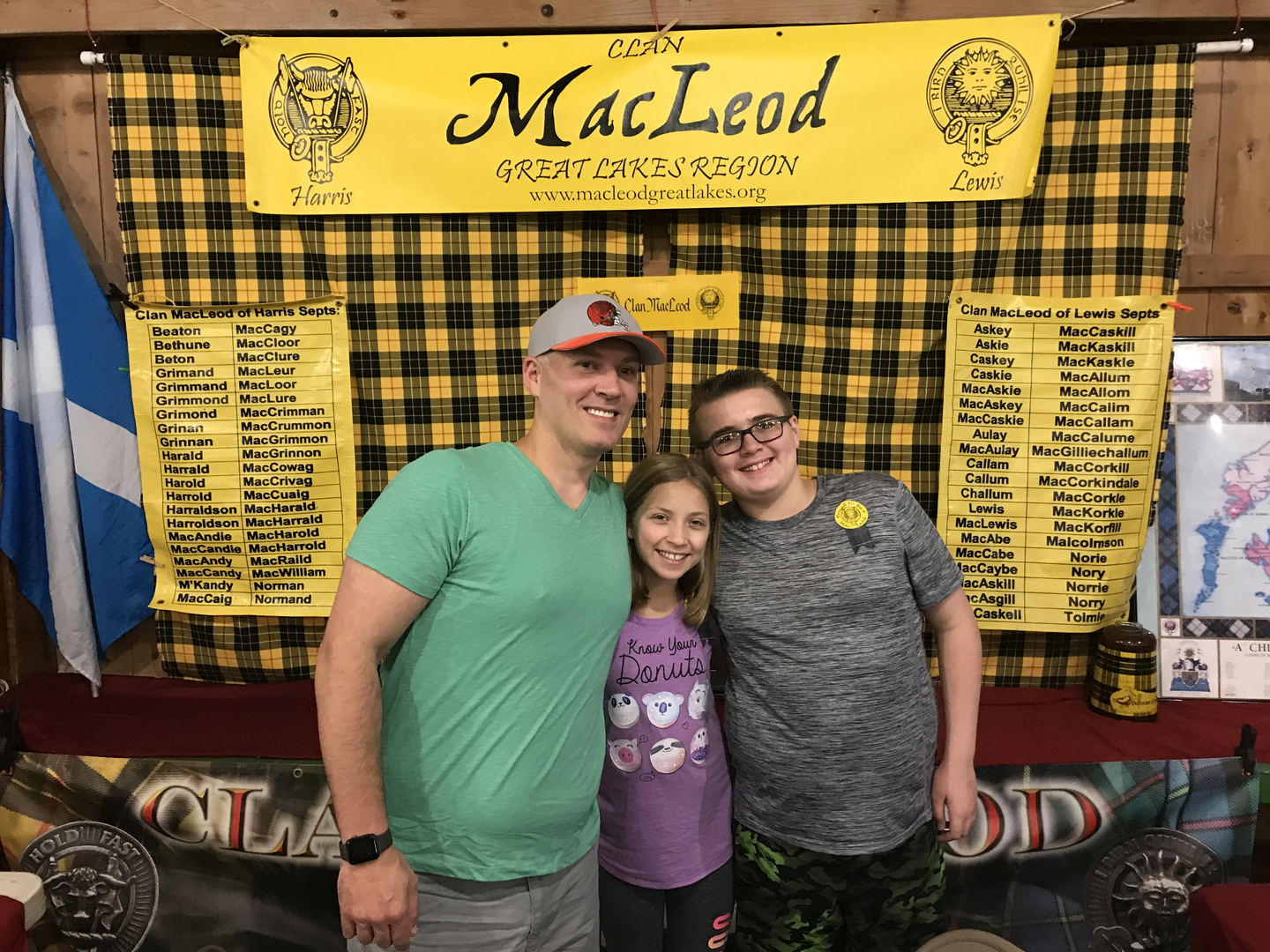 Three people smiling at MacLeod clan booth.