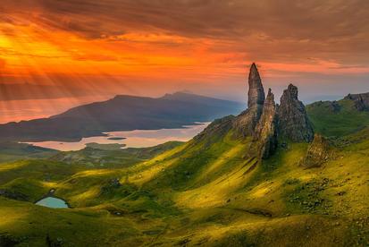 Dramatic sunset over rugged mountain landscape.