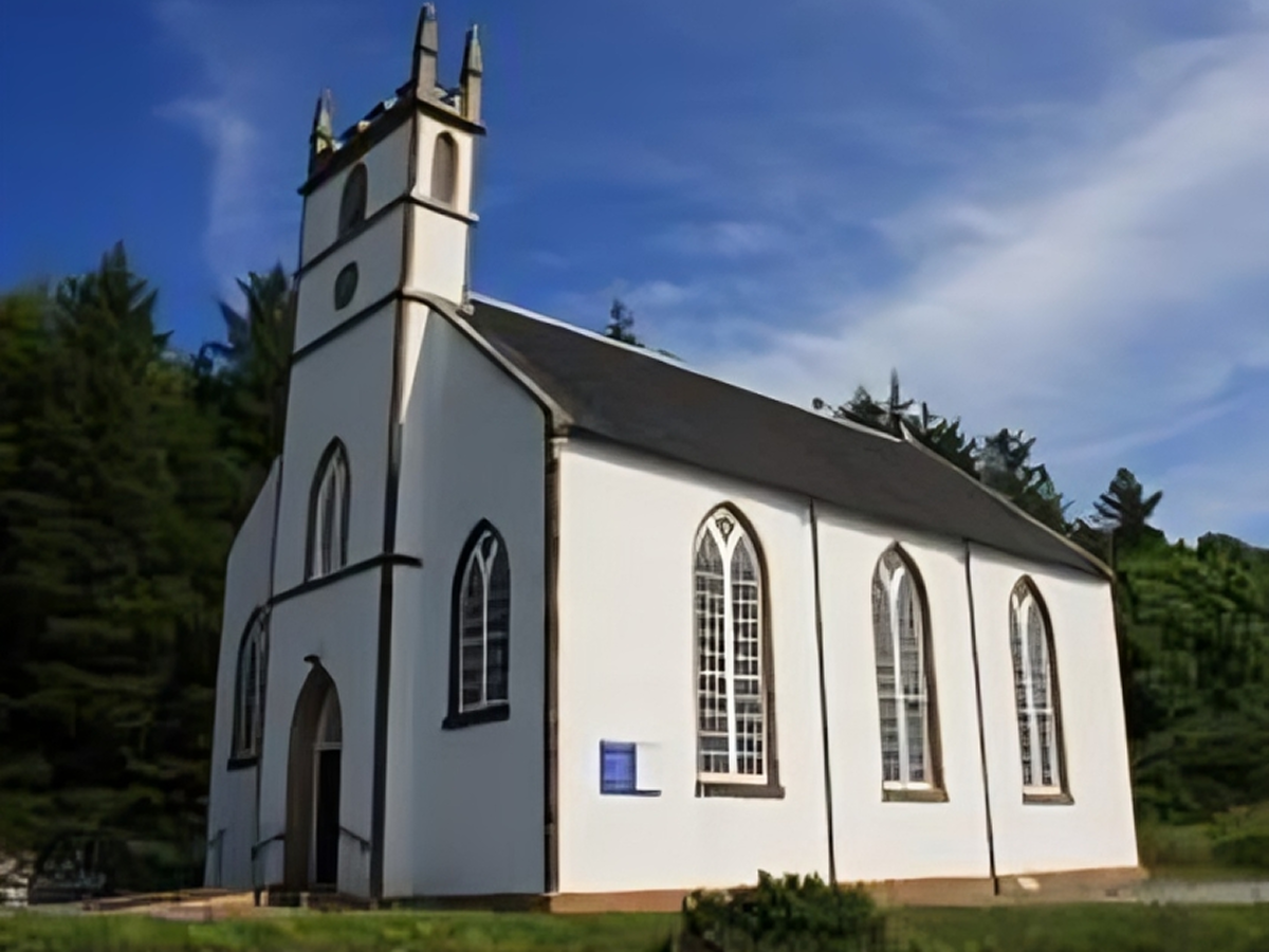 White church with tall arched windows.