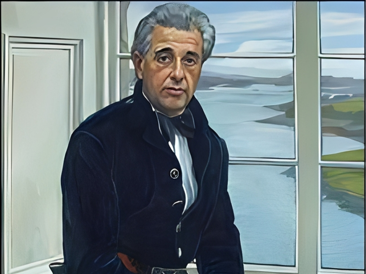 Man sitting by window overlooking water.