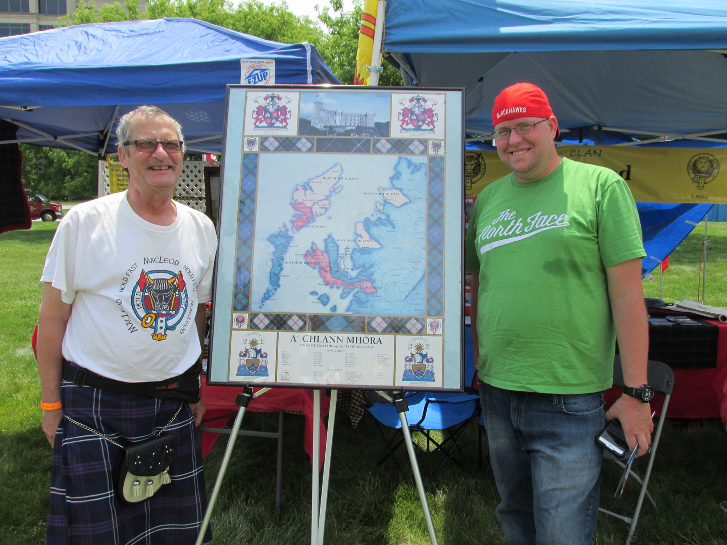 Two men standing by a colorful map.