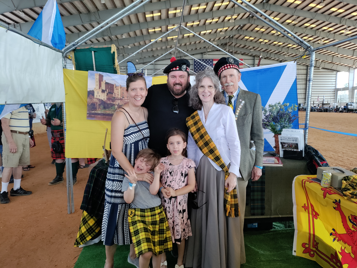 Family wearing tartan at cultural festival booth.