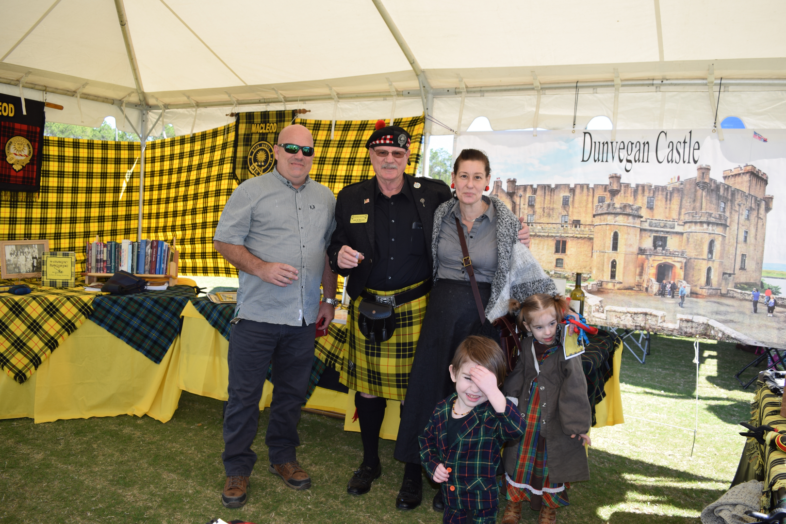 Family posing in front of castle display.