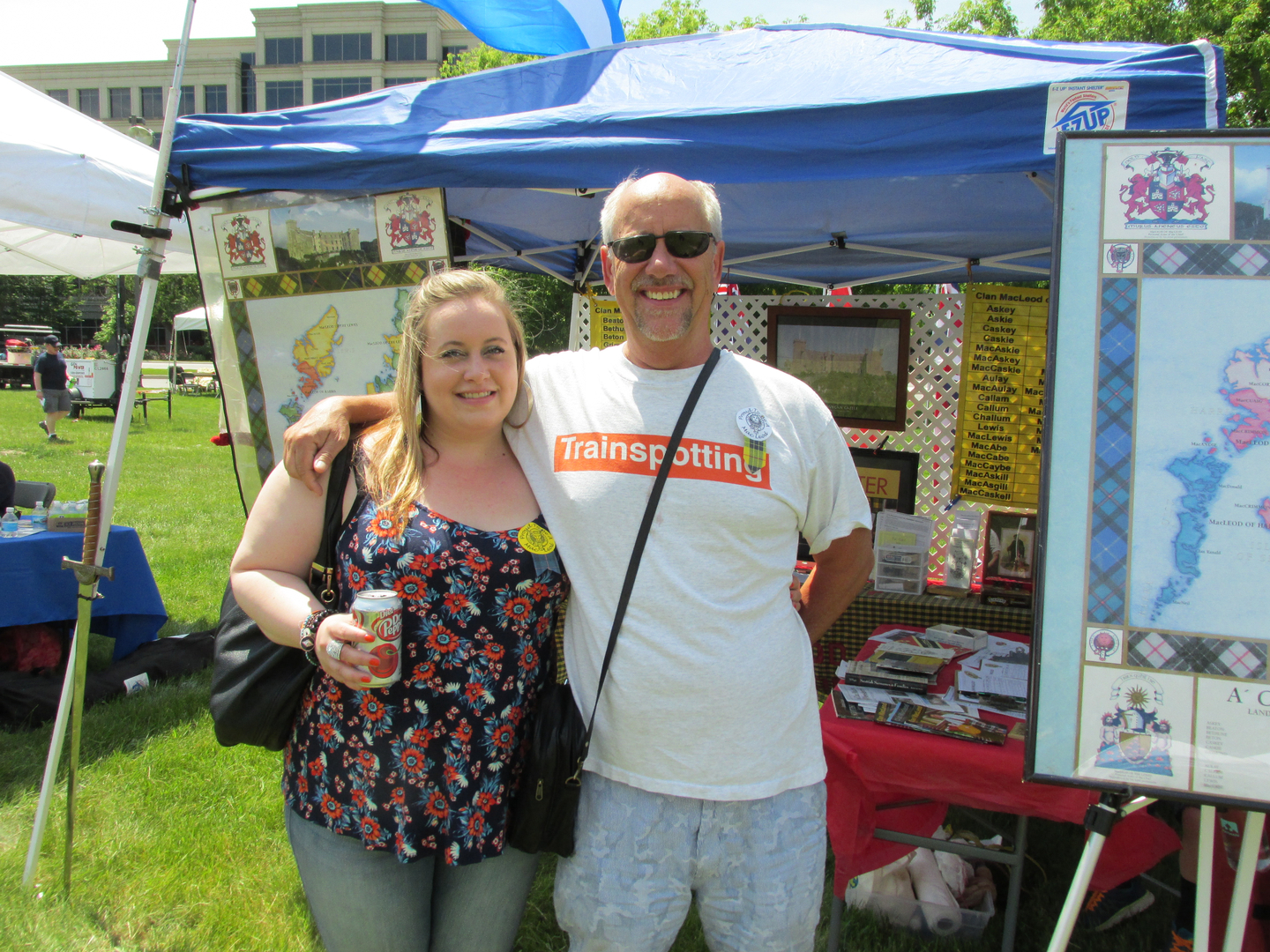 Smiling couple at outdoor market booth.