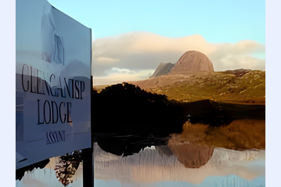 Mountain view with lodge sign reflection.